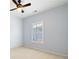 This bedroom has a ceiling fan, a large window, and modern wallpaper at 6484 Century Park Se Pl, Mableton, GA 30126