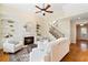 Inviting living room featuring a fireplace, built-in shelving, and a staircase at 6484 Century Park Se Pl, Mableton, GA 30126