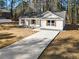 Modern farmhouse style home with a long driveway and surrounding trees at 2716 Battle Sw Trl, Marietta, GA 30064