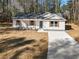 Single-story house with gray roof and white siding, driveway, and yard at 2716 Battle Sw Trl, Marietta, GA 30064