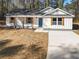 Single-story house with gray roof and white siding, long driveway at 2716 Battle Sw Trl, Marietta, GA 30064