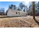 A well-maintained backyard featuring a freshly painted white house and a cozy patio area at 2716 Battle Sw Trl, Marietta, GA 30064