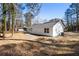 Rear exterior view of the home in a large wooded lot at 2716 Battle Sw Trl, Marietta, GA 30064