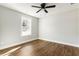 Well-lit bedroom with wood floors, a window, and ceiling fan at 2716 Battle Sw Trl, Marietta, GA 30064