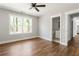 Bedroom featuring hardwood floors, bright window view, and adjoined bathroom at 2716 Battle Sw Trl, Marietta, GA 30064