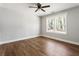 Bright bedroom features hardwood floors, modern ceiling fan, and double hung windows at 2716 Battle Sw Trl, Marietta, GA 30064