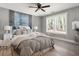 Bright bedroom featuring a ceiling fan, hardwood floors and large windows with natural light at 2716 Battle Sw Trl, Marietta, GA 30064