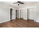 Bright bedroom features a ceiling fan, three closets, wood-look floors, and neutral walls at 2716 Battle Sw Trl, Marietta, GA 30064