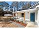 Charming white house with blue door, wood accents, and a covered porch at 2716 Battle Sw Trl, Marietta, GA 30064