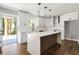 Bright, eat-in kitchen features white cabinets, quartz counters, wood floors, and stainless steel hood at 2716 Battle Sw Trl, Marietta, GA 30064