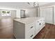 Spacious kitchen island with white countertop, dark hardware, and wood flooring in an open concept layout at 2716 Battle Sw Trl, Marietta, GA 30064