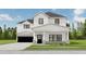 Two-story farmhouse with white siding, black windows, and a stone facade at 614 Charlotte Pl Nw, Atlanta, GA 30318