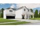 Two-story farmhouse with white siding, black windows, and a stone facade at 614 Charlotte Pl Nw, Atlanta, GA 30318