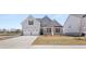 Two-story house with a three-car garage and landscaping at 13561 Whitman Ln, Covington, GA 30014