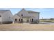 Exterior of house with spacious backyard, covered porch, and view of surrounding landscape at 13561 Whitman Ln, Covington, GA 30014