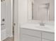 Bright bathroom featuring a white vanity, large mirror, and a shower-tub combination at 13561 Whitman Ln, Covington, GA 30014