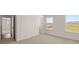 Bedroom with neutral carpet and a view of the neighborhood from its bright windows at 13561 Whitman Ln, Covington, GA 30014