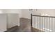 Second floor hallway featuring hardwood floors, white trim and an elegant chandelier at 13561 Whitman Ln, Covington, GA 30014