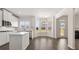 Bright open kitchen with stainless steel appliances, white cabinets, and a bay window at 13561 Whitman Ln, Covington, GA 30014