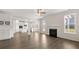 Open concept living room featuring a fireplace, hardwood floors and views into the modern kitchen at 13561 Whitman Ln, Covington, GA 30014
