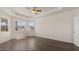 Bright main bedroom featuring hardwood floors, large windows, and a trey ceiling at 13561 Whitman Ln, Covington, GA 30014