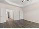 Spacious main bedroom showcasing a tray ceiling and an ensuite bath with tile floors at 13561 Whitman Ln, Covington, GA 30014