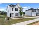 Two-story white house with black shutters and a paved driveway at 209 Friendship Oak Way, Hampton, GA 30228