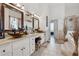 Elegant bathroom with double vanities, soaking tub and separate shower at 4497 Black Water Cv, Ellenwood, GA 30294