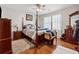 Main bedroom with hardwood floors and a four poster bed at 4497 Black Water Cv, Ellenwood, GA 30294