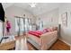 Bedroom with a queen-size bed and light pink decor at 4497 Black Water Cv, Ellenwood, GA 30294