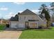 Two-story house with attached garage and landscaped yard at 4497 Black Water Cv, Ellenwood, GA 30294