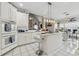 White kitchen with island and marble countertops at 4497 Black Water Cv, Ellenwood, GA 30294