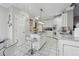 White kitchen with island, breakfast bar and stainless steel appliances at 4497 Black Water Cv, Ellenwood, GA 30294