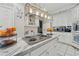 Bright kitchen features stainless steel appliances and an island with marble countertop at 4497 Black Water Cv, Ellenwood, GA 30294