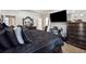 Main bedroom with a king-size bed, large TV and dark wood furniture at 4497 Black Water Cv, Ellenwood, GA 30294