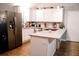 Modern kitchen with white cabinets, granite countertops, and stainless steel appliances at 115 S Meadowcliff Cir, Carrollton, GA 30116