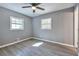 Gray walls, wood-look flooring, ceiling fan in this bedroom at 1679 Hollyhock Ter, Decatur, GA 30032