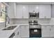 Stylish kitchen with white cabinets and quartz countertops at 1679 Hollyhock Ter, Decatur, GA 30032