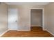 Empty bedroom with wood-look floors and closet at 2491 Crumps Landing Cir, Snellville, GA 30039