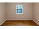 Simple bedroom with wood-look floors and window at 2491 Crumps Landing Circle, Snellville, GA 30039