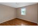 Simple bedroom with wood flooring and a window at 2491 Crumps Landing Circle, Snellville, GA 30039