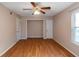 Spacious bedroom with wood-look floors and ceiling fan at 2491 Crumps Landing Circle, Snellville, GA 30039