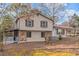 Beige two-story house with stone accents and covered porch at 2491 Crumps Landing Cir, Snellville, GA 30039