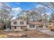 Two-story house with beige siding, stone accents, and carport at 2491 Crumps Landing Cir, Snellville, GA 30039