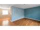 Living room with light blue walls and wood floors at 2491 Crumps Landing Cir, Snellville, GA 30039