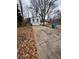 Long driveway leading to a white house with a two car garage at 702 Talemwood Ct, Lawrenceville, GA 30044