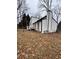 House with white siding, black accents, and a deck at 702 Talemwood Ct, Lawrenceville, GA 30044