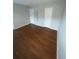 Simple bedroom with wood-look flooring and neutral walls at 894 Glynn Oaks Dr, Clarkston, GA 30021