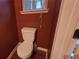 Small half bathroom with toilet and hardwood floor at 3551 Brycewood Dr, Decatur, GA 30034