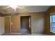Bright bedroom with neutral walls, ceiling fan, and access to another room at 3551 Brycewood Dr, Decatur, GA 30034